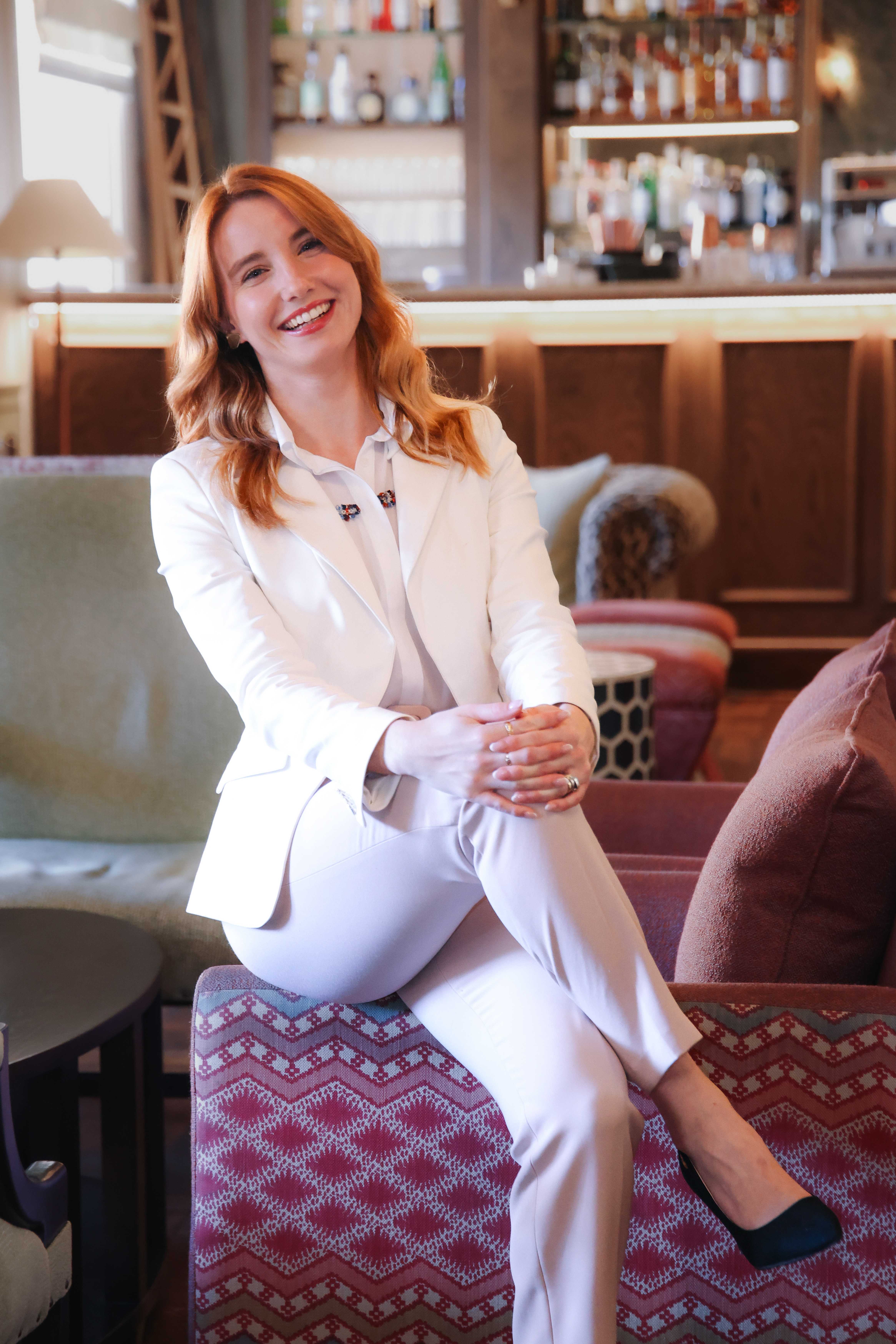 Elizabeth O'Donnell, founder of Habitus Haus, seated in a hotel lounge